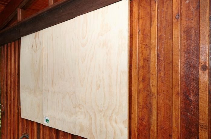 A window fully cyclone proofed with plywood boarding