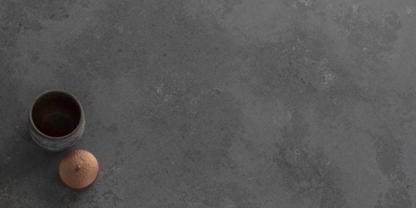 A piece of grey stone benchtop with a vase on it