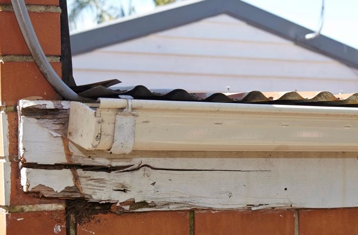 Guttering hanging from a rotted timber fascia board