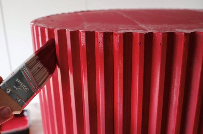 Person painting table with paintbrush