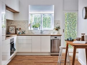 Modern kitchen with a small stainless steel dishwasher.