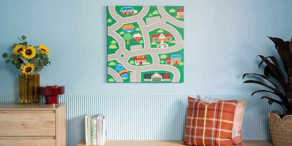  Nostalgic wall art featuring a road map with houses and trees