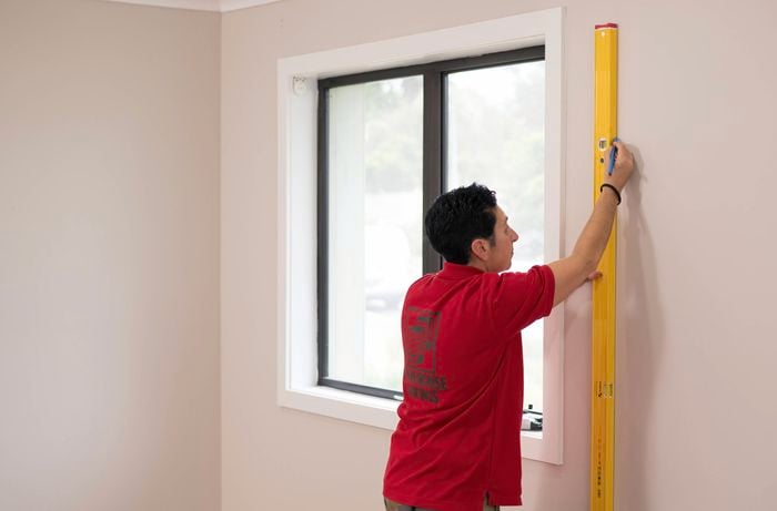 Mark a string line on the floor and wall with a spirit level near a window. 