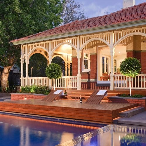 Heritage style house with decking around pool.