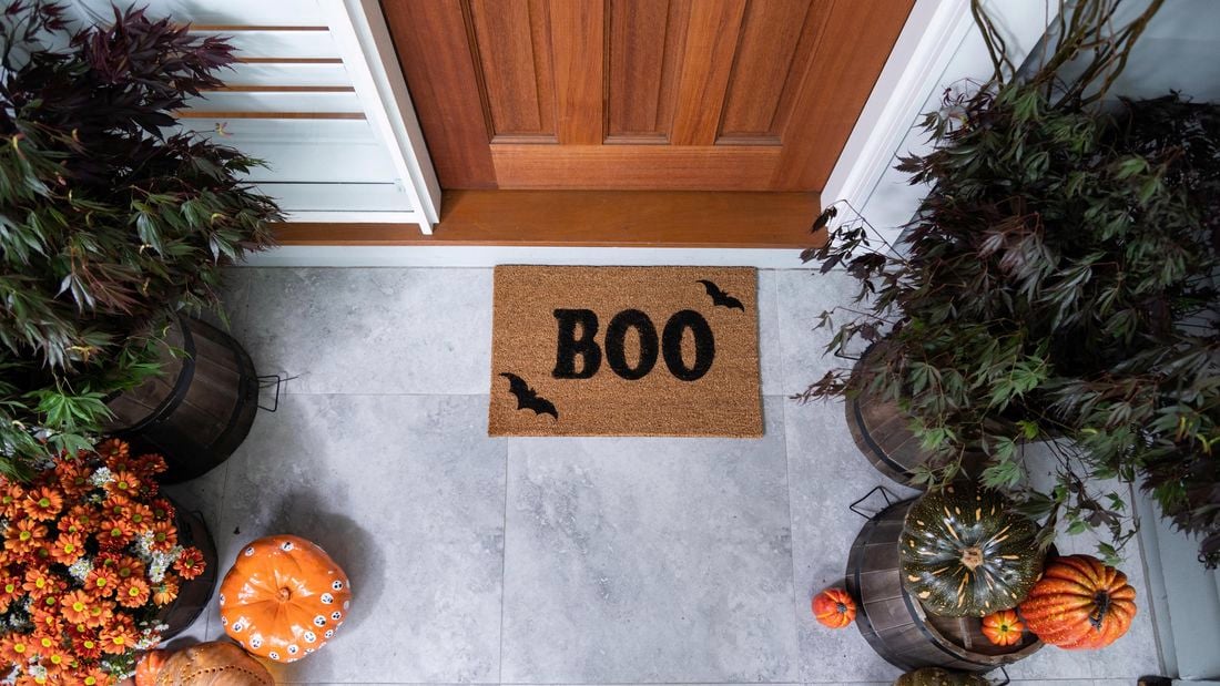 Front door mat with the words Boo stencilled on it