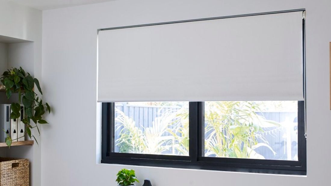 White Riva blinds in a home office interior.