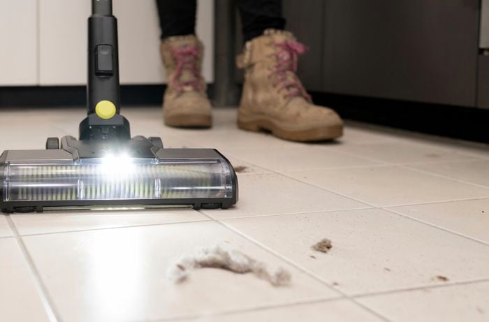 A person vacuuming the floor.