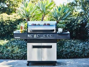 Four burner BBQ in a backyard