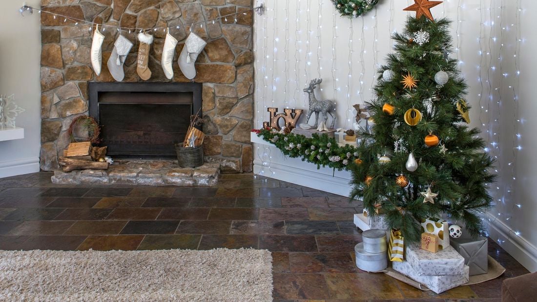 Small tree set up in room with fireplace