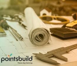 Paper floorplans for a building with calculator, glasses and silver pen.