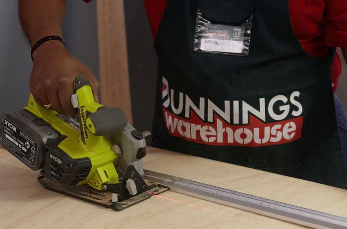 Person cutting ply with circular saw