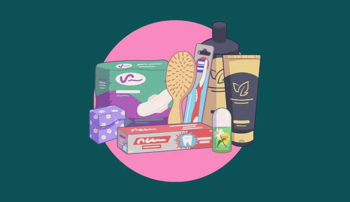 Illustration of essential toiletries and personal care items, including shampoo, toothpaste, toothbrush, hairbrush and period products, against a pink circle on a dark green background.