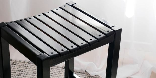 A polished black stool.