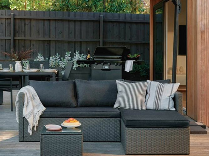Outdoor setting, decorated table and BBQ on a timber decking outdoors