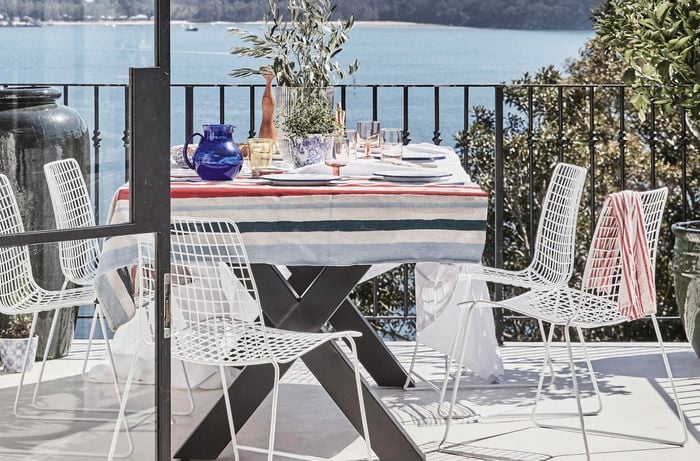 Balcony with outdoor setting and views of the ocean