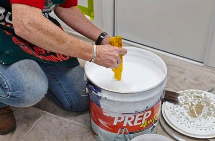 Person stirring paint.