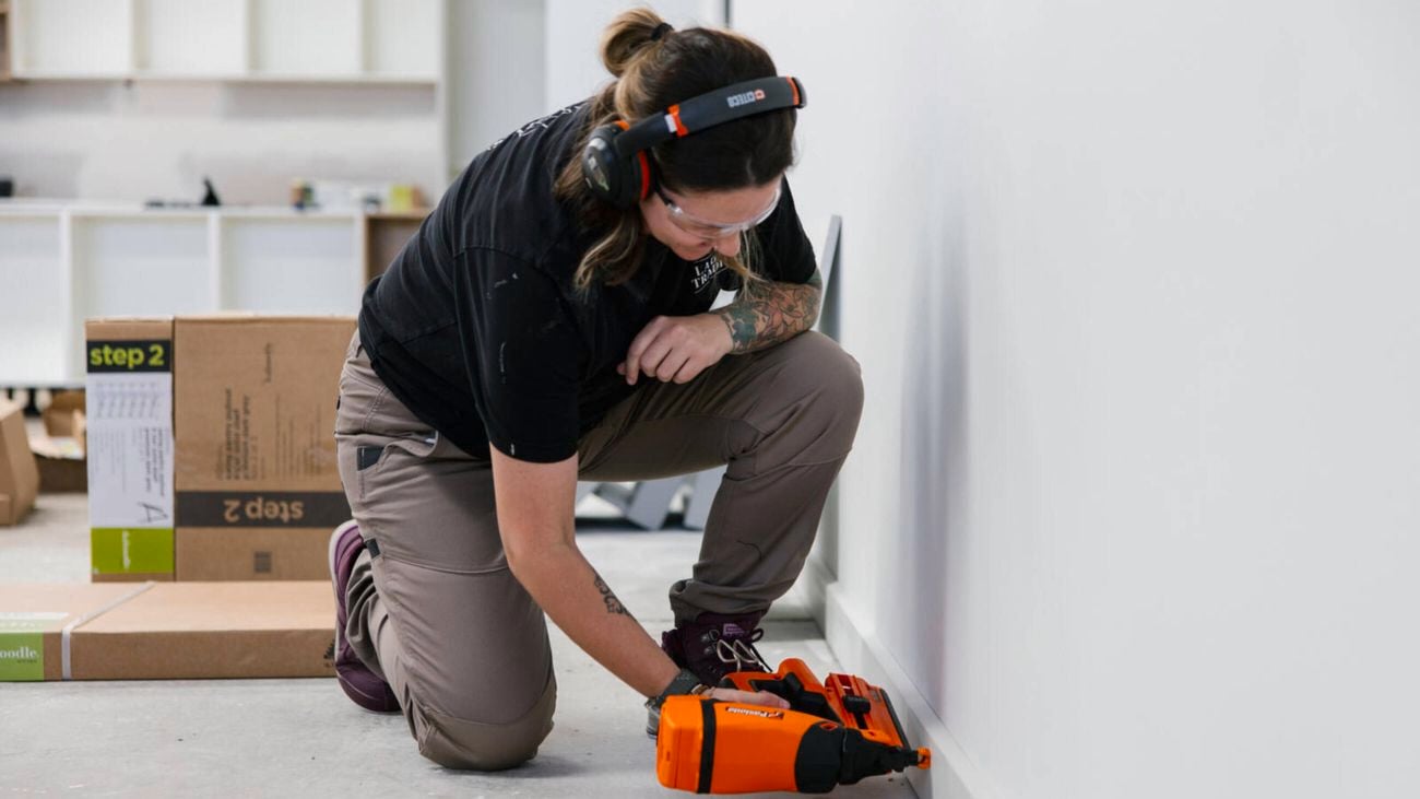 Female tradesperson Daisy Smark of No.1 Lady Tradie uses the Paslode NightWolf FrameMaster in an indoor work site