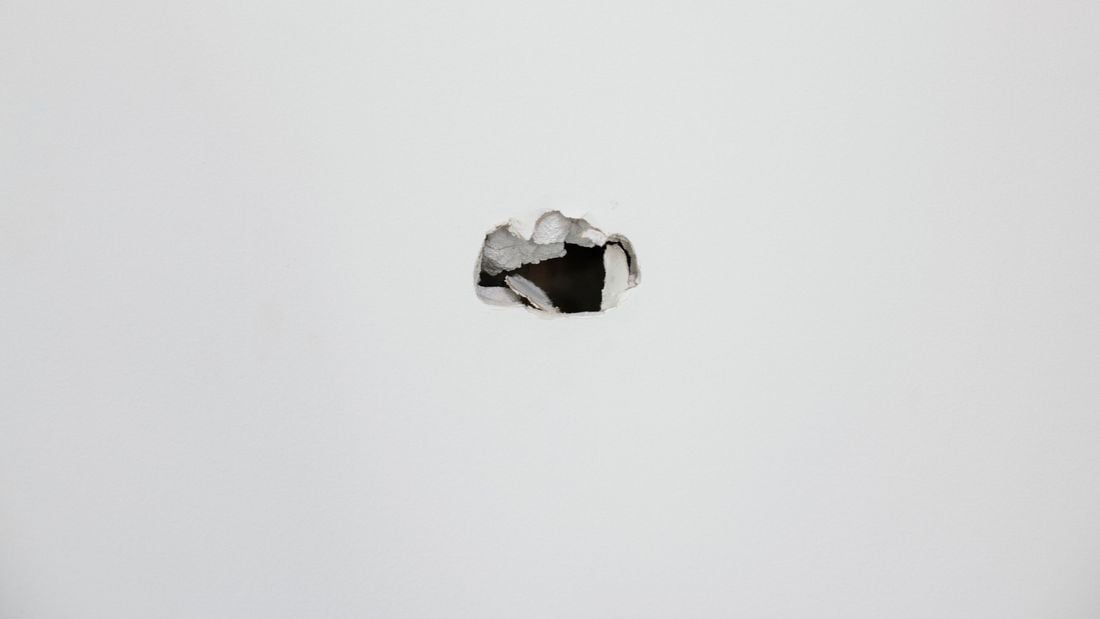 A hole in a white wall