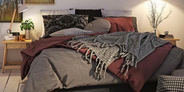 a bedroom with bed and wall art