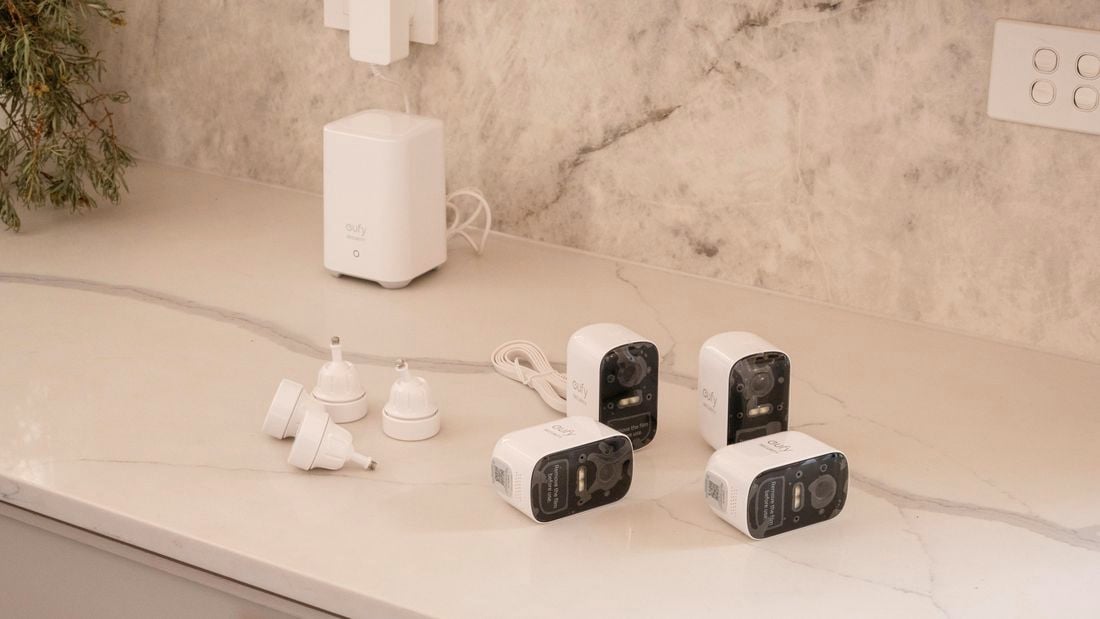 Four security cameras on top of a countertop.
