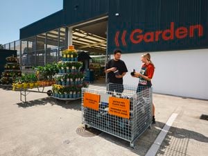 Pot recycling project with team and customer in front of cage