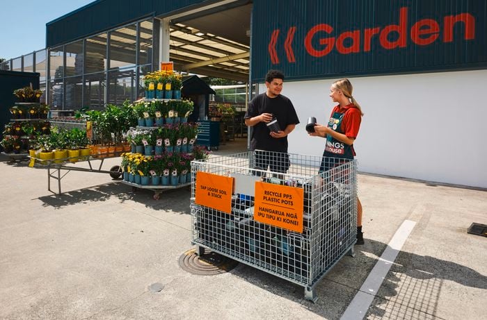Pot recycling project with team and customer in front of cage