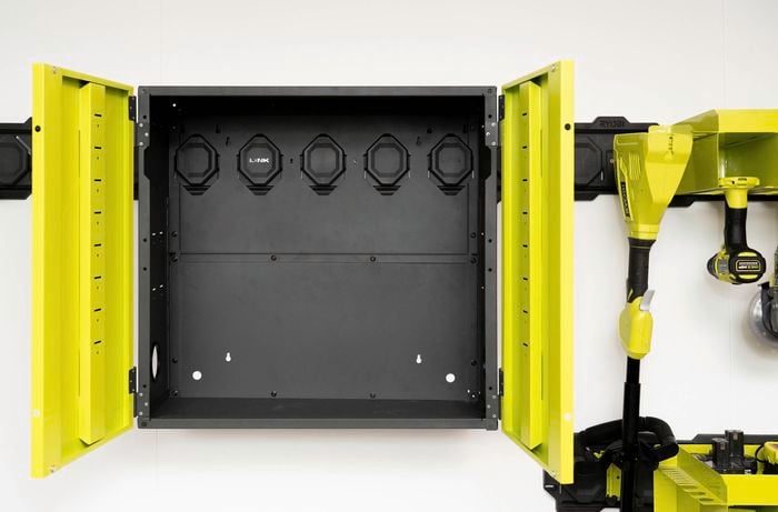 A Ryobi LINK wall-mountable cabinet is installed on the rail system, ready to store tools, batteries and chargers