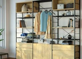 An image of an open wardrobe made from Flexi Storage Studio Silhouette shelving units in Black and Oak, with open shelves, 2 drawer units and a cabinet in Oak