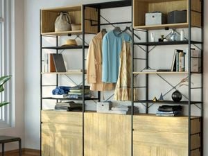  An image of an open wardrobe made from Flexi Storage Studio Silhouette shelving units in Black and Oak, with open shelves, 2 drawer units and a cabinet in Oak