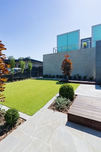 A lawn and stone paving as part of the outdoor area of a functionalist building
