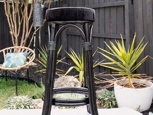Cane bar stool painted black with black fabric seat 