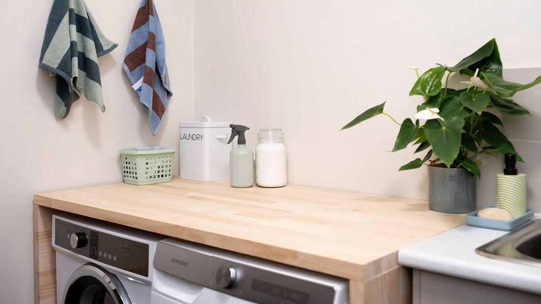 Space-saving laundry table installed over a washing machine and dryer
