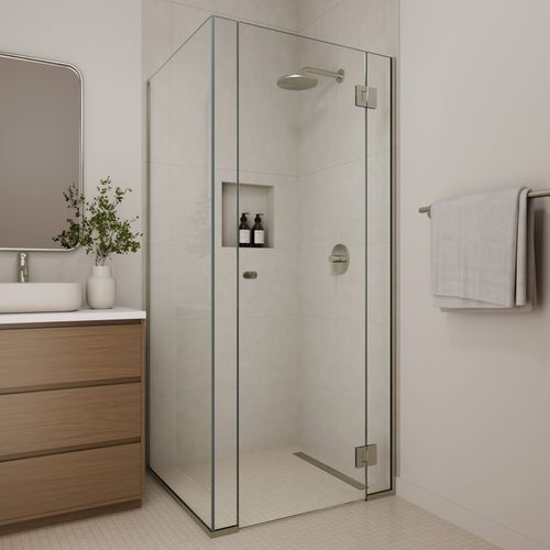 Walk-in shower screen with brushed nickel fittings, clear glass panel, and contemporary bathroom design.
