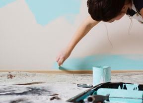 Painting a wall with blue paint