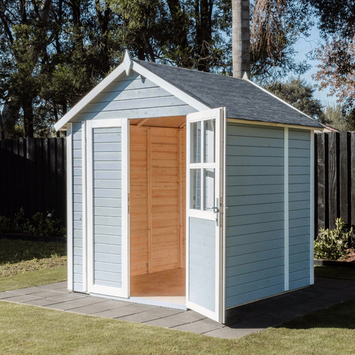 Light blue garden shed with pitched roof and glazed double doors standing open, showing a spacious empty timber-lined interior.