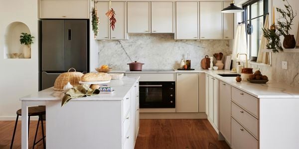 Image of white kitchen with white cabinetry and stone benchtop 