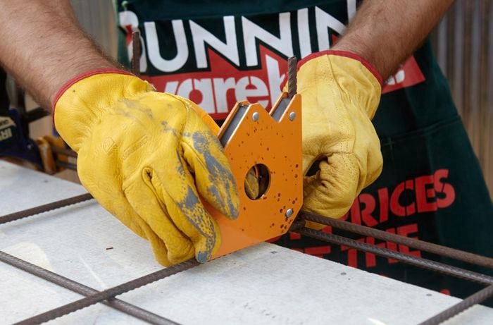 A magnetic welding clamp being fixed to a wire mesh frame