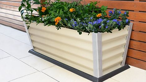 Corrugated planer box containing flowers and vegetables