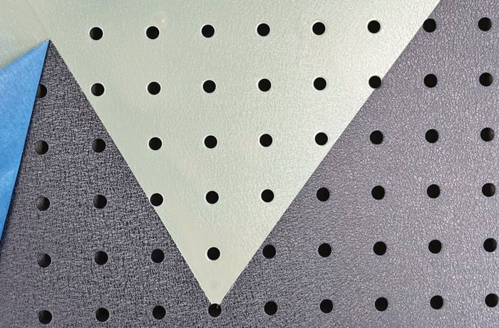 blue painters tape being removed from pegboard to show final black and green grey design