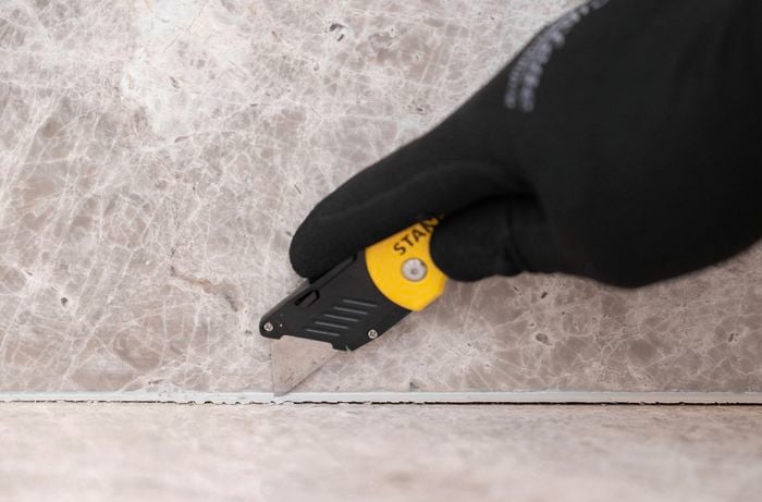 Remove silicone using a sharp utility knife
