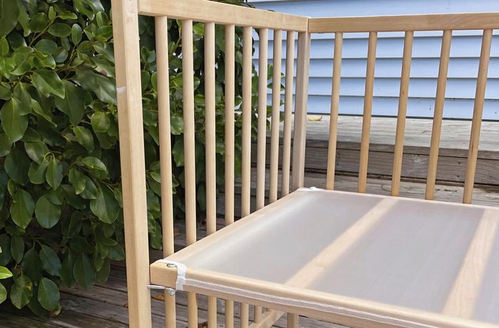 Wooden cot with front gate removed