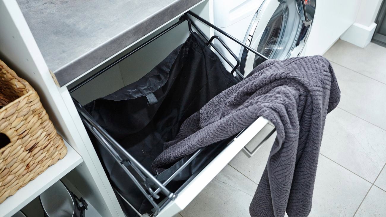 A 450mm laundry chute with a grey towel draped over it.