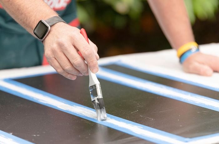 Paint is added to the chalk scoreboard