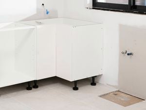  white corner base cabinets fully assembled and installed in a kitchen