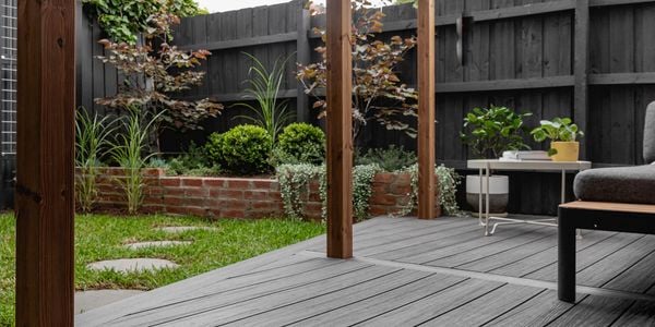 Backyard decking area with timber sleepers connected by channels 