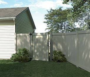 tall solid timber fencing around a backyard, with an open gate