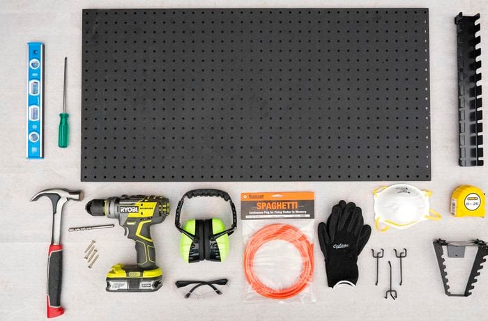 Pegboard, spirit level, safety equipment, screwdriver and various other tools.