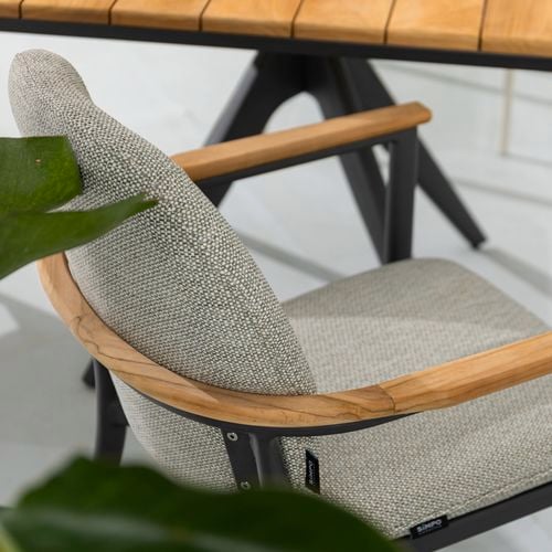 Close up of an aluminium outdoor dining chair with teak armrests