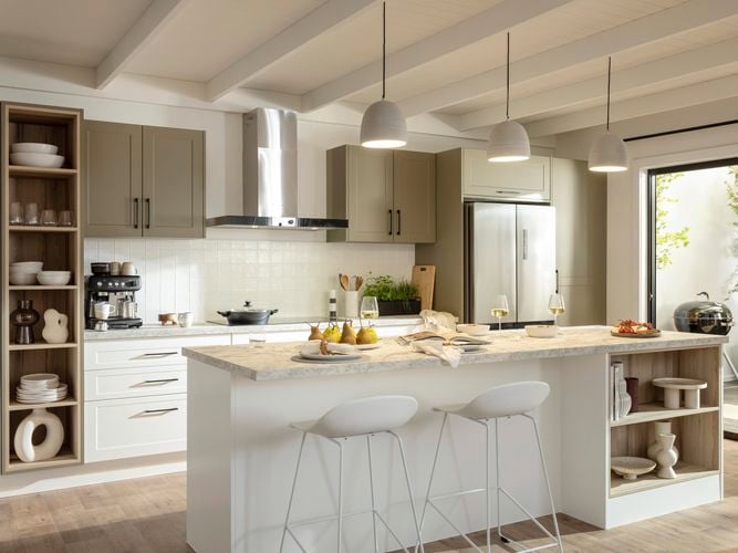 Neutral themed kitchen styled with stools, pendants, island benchtop and timber flooring .