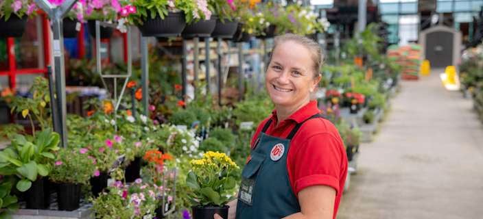 Female Bunnings Team Member in the Outdoor Nursery with plants.